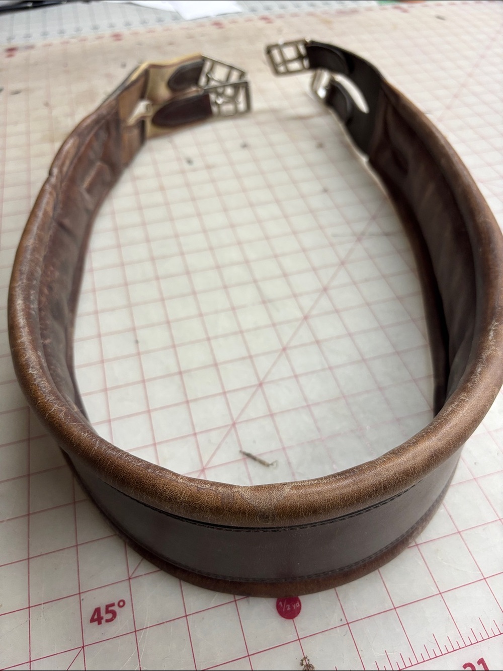 Lovely, custom made leather girth-52”. Padded, elastic on one end.